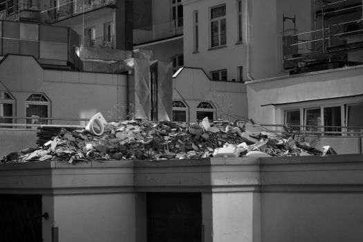 Monochrome view of construction debris on a rooftop in a city setting.